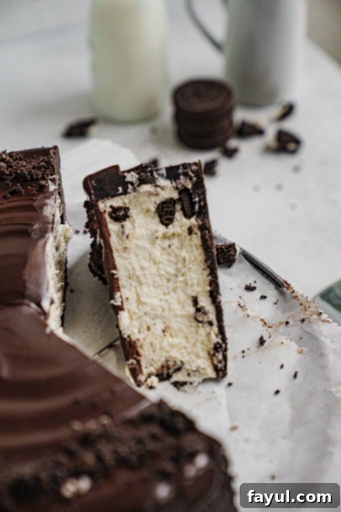 A slice of no-bake Oreo cheesecake on a plate, showing the layers