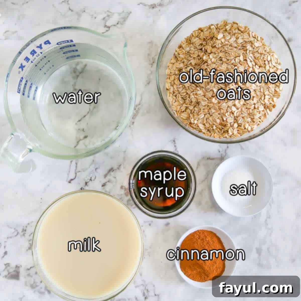 Overhead shot of ingredients - water, old fashioned oats, maple syrup, milk, cinnamon, and salt, neatly arranged.