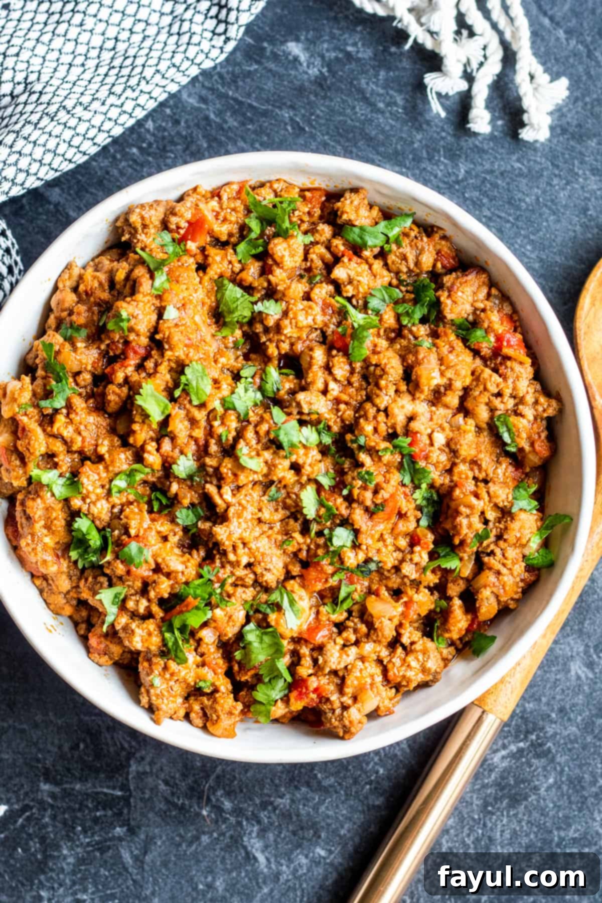 Overhead shot of perfectly seasoned Instant Pot taco meat in a white serving bowl, ready to be enjoyed.