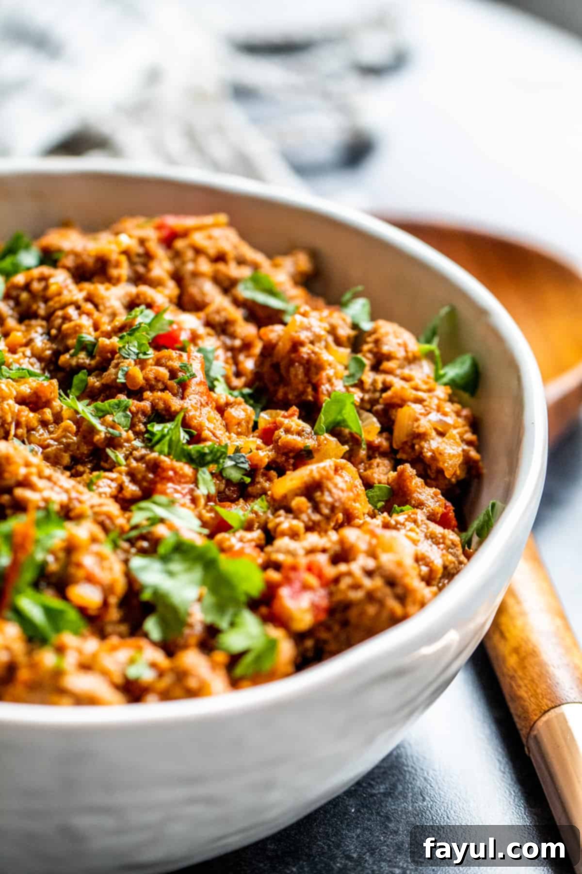 Angle shot of meat in white bowl.