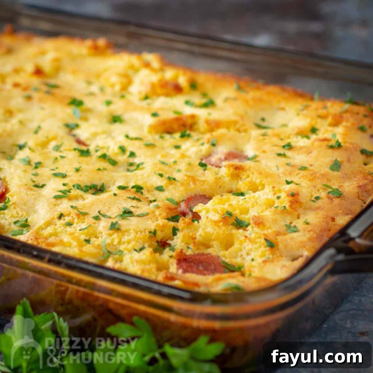 Side close up shot of casserole in a clear dish garnished with fresh herbs.