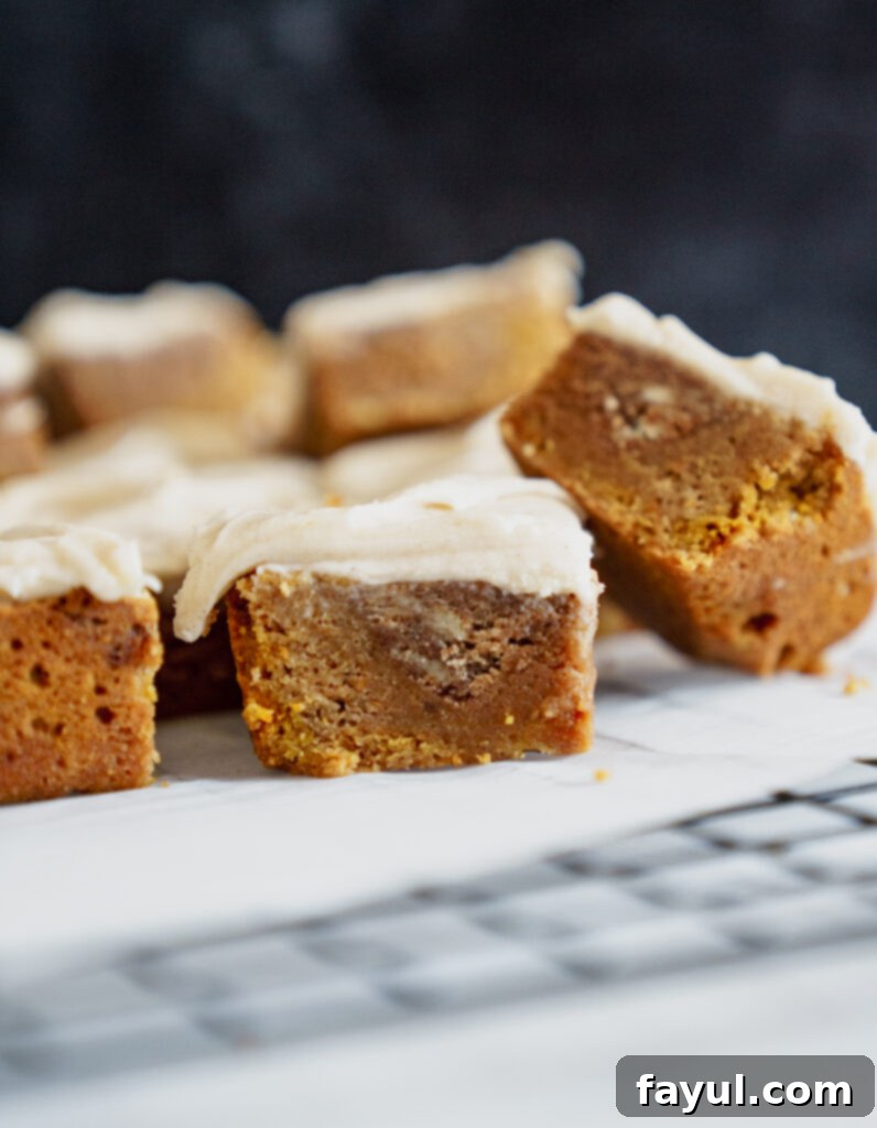 Two squares of Pumpkin Cinnamon Roll Blondies on a plate