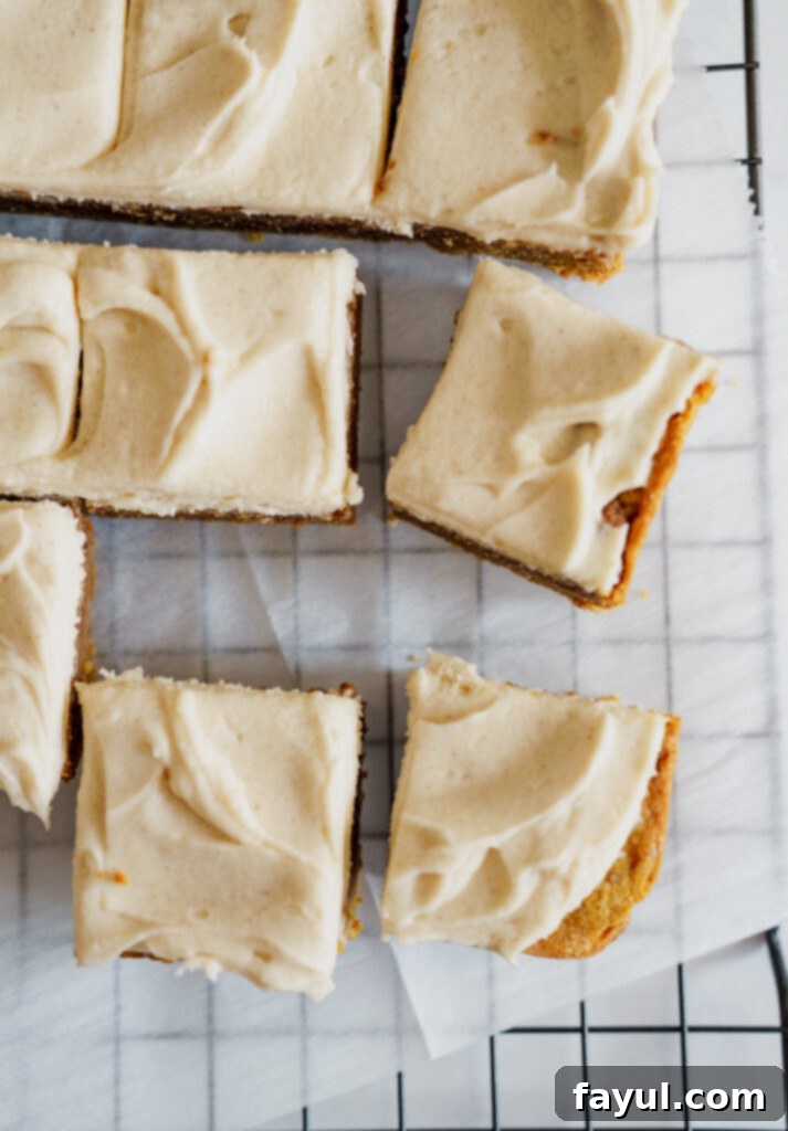 Pumpkin Cinnamon Roll Blondies close-up with a spoon taking a bite