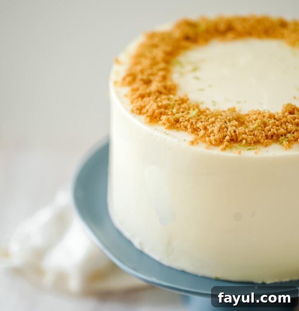 A beautifully decorated Coconut Key Lime Pie Cake with frosting swirls