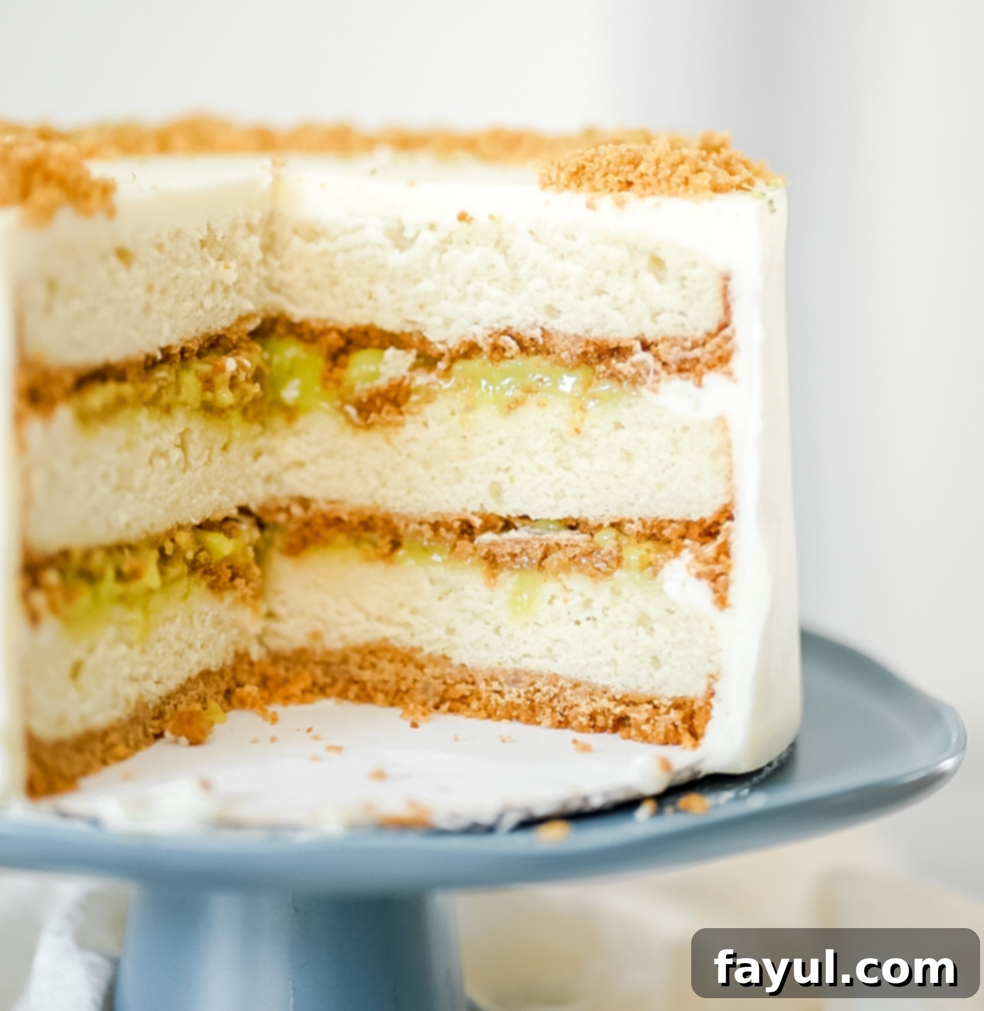 Coconut Key Lime Pie Cake with frosting, ready to serve