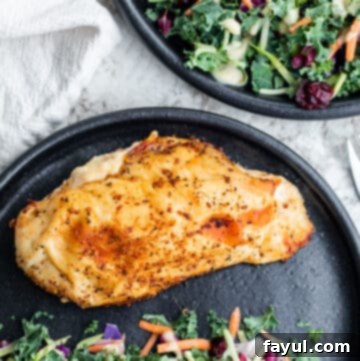 Air Fryer Cheesy Stuffed Chicken 9 Overhead shot of chicken on black plate with side salad.