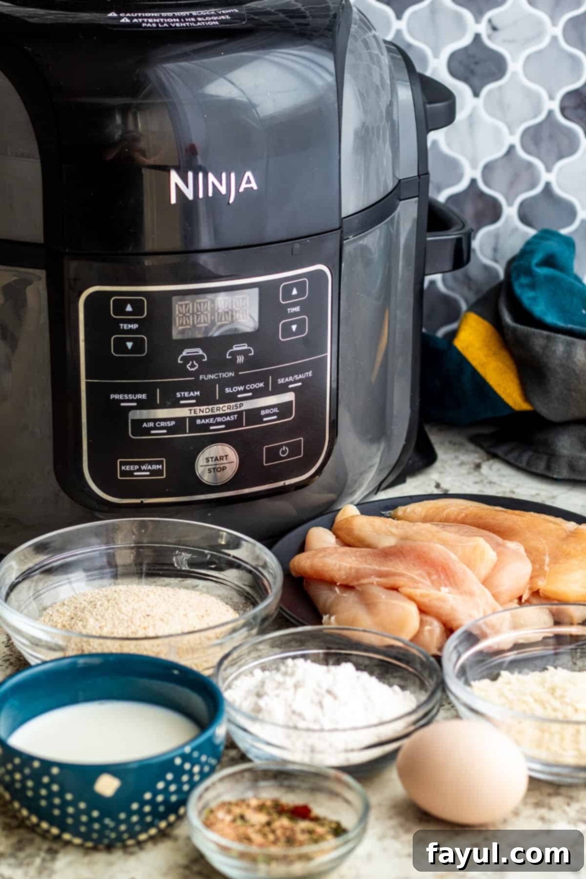 Recipe ingredients laid out on a white counter in small bowls and plates, ready for preparation.