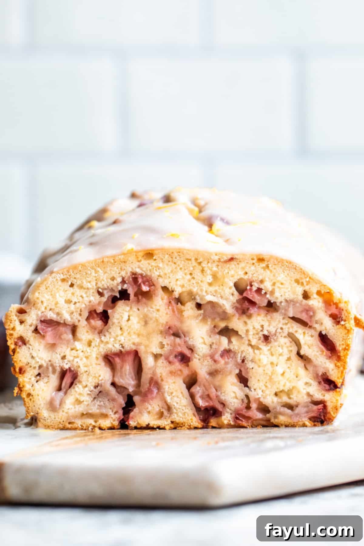 Sunshine Strawberry Lemon Loaf 8 Straight-on shot of a perfectly baked and glazed strawberry loaf cake, presented whole on a white background, inviting a slice.