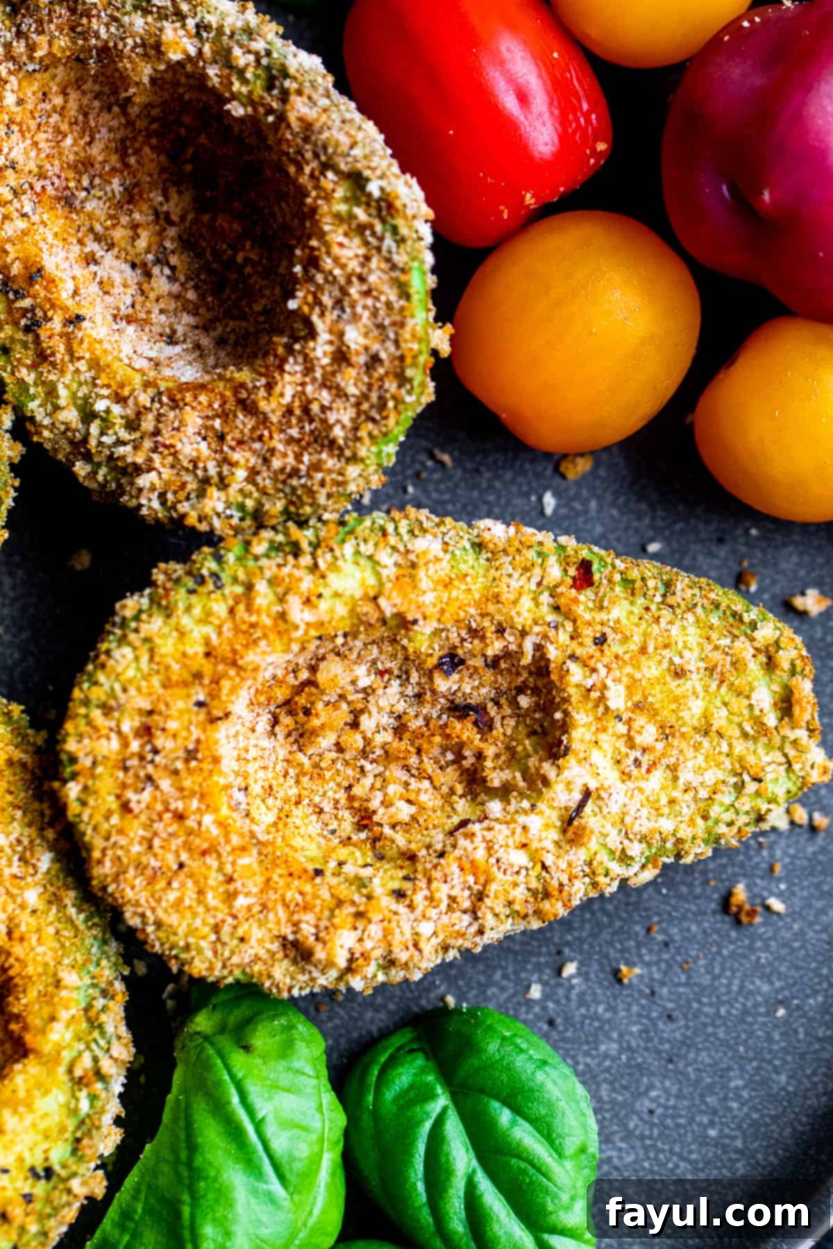 Speedy and Simple Air Fryer Avocados 6 Overhead shot of breaded avocados on gray plate.