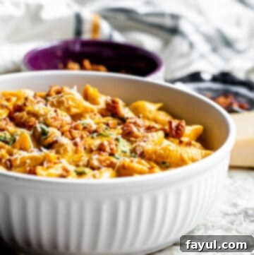Velvety One-Pan Pumpkin Pasta 10 Pasta in a white bowl on white counter top.