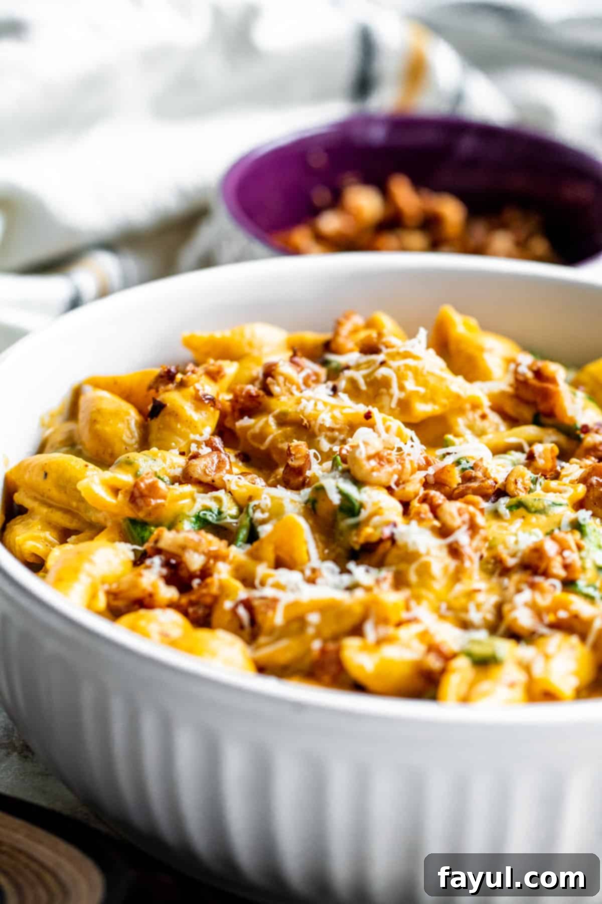 Velvety One-Pan Pumpkin Pasta 6 Angle shot of pumpkin pasta in white bowl.