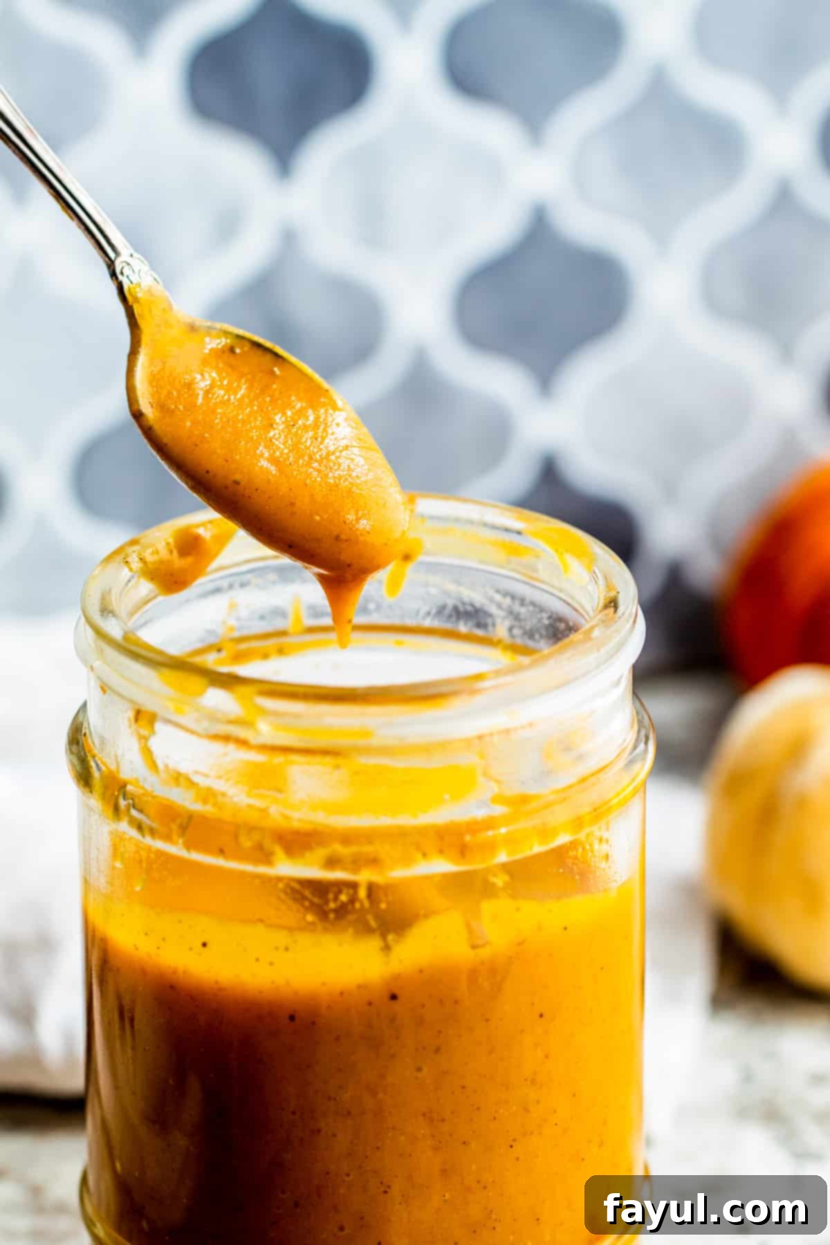 Silver spoon scooping dressing out of jar.