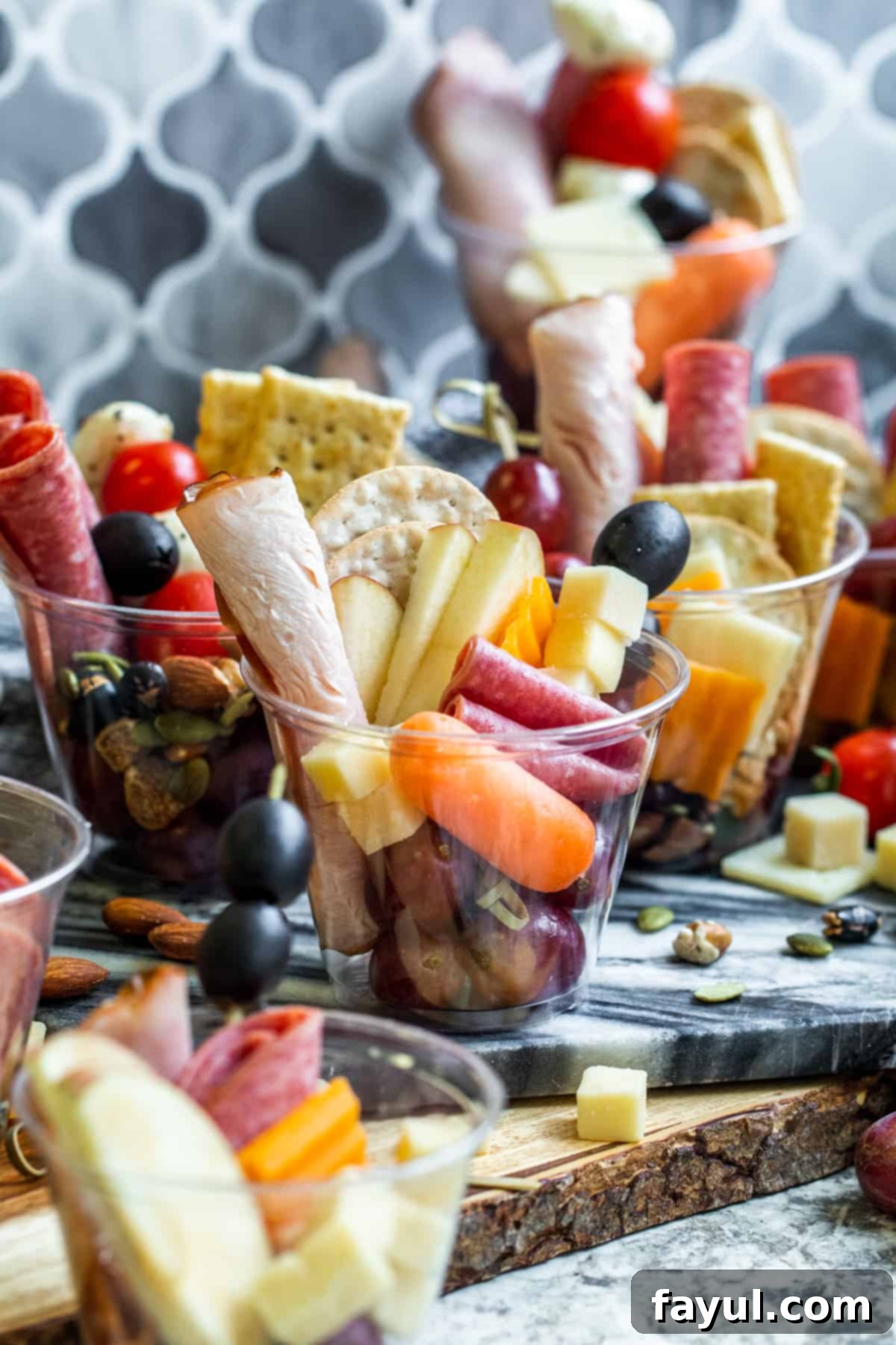 Charcuterie cups scattered on counter.
