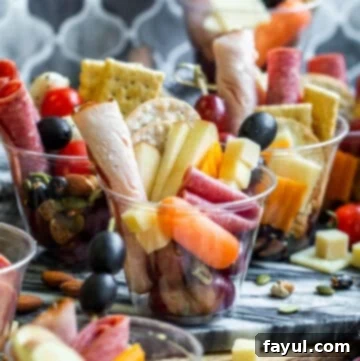Charcuterie cups scattered on counter.