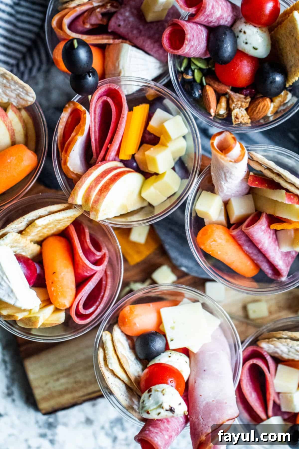 Overhead shot of individual appetizer cups on white counter.