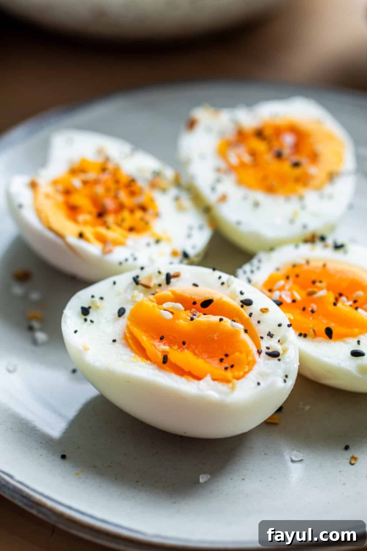 Effortless Air Fryer Hard-Boiled Eggs 48 Close up of sliced hard boiled eggs on gray plate.