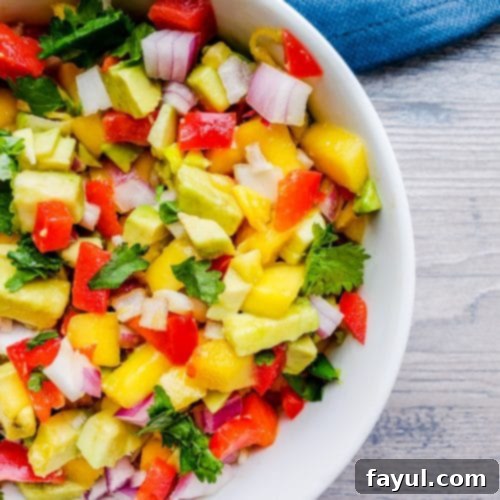 This Easy Mango Avocado Salsa is the BEST fresh summer salsa made with mango, avocado, cilantro, red onion and red pepper. Perfect on its own with chips or paired with your favorite Mexican food like tacos! #salsa #healthy #vegan #vegetarian
