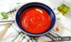 Marinara sauce in a small blue pot. 