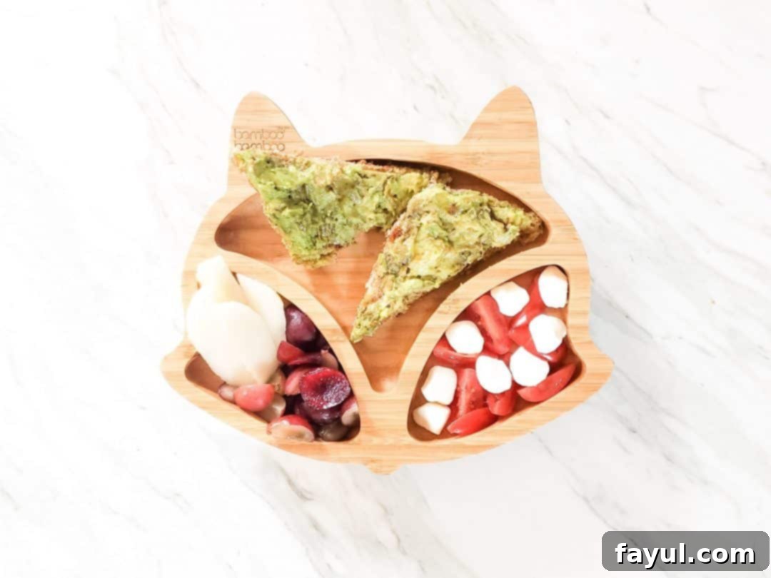 Avocado Toast BLW meal ideas. This photo is a fox plate on a marble table with my son's lunch in it. The lunch has cherries, grapes, pear, mozzarella cheese, tomatoes, and avocado on toast.