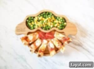 Naan pizza sticks with peas and corn on a bamboo bamboo sheep plate.