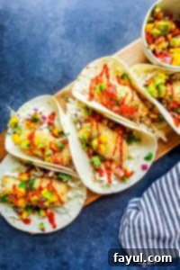 Crispy Baked Coconut Crusted Healthy Fish Tacos with vibrant Mango Avocado Salsa, a perfect under 30-minute family weeknight dinner. Featuring golden-baked cod and a refreshing cilantro lime cabbage slaw.