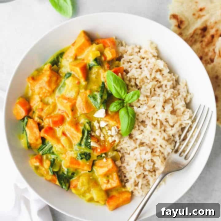 Vibrant and creamy sweet potato curry garnished with fresh herbs, a comforting and healthy vegetarian meal.