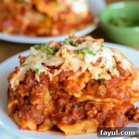 Hearty and cheesy crock pot lasagna, layered with pasta, meat sauce, and ricotta, a comforting and easy meal.
