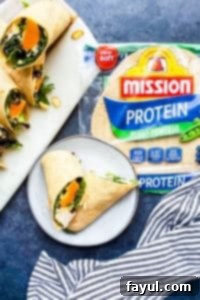 Several wraps on a blue counter and one on a gray plate.