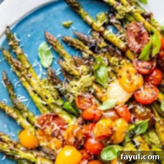 Overhead shot of asparagus on a blue and white plate on blue counter, presented as a finished dish.