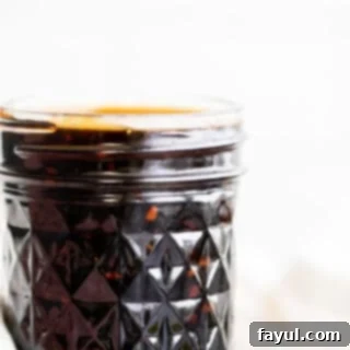 Teriyaki sauce in a glass mason jar.