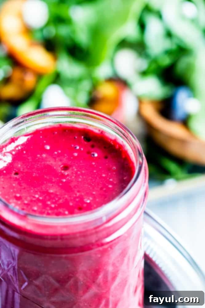 Blueberry dressing in a glass mason jar, showcasing its vibrant color and smooth texture.