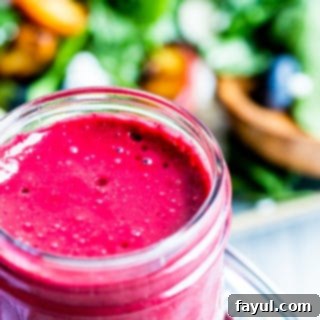 Blueberry dressing in a glass mason jar, a fresh and vibrant homemade salad topping.