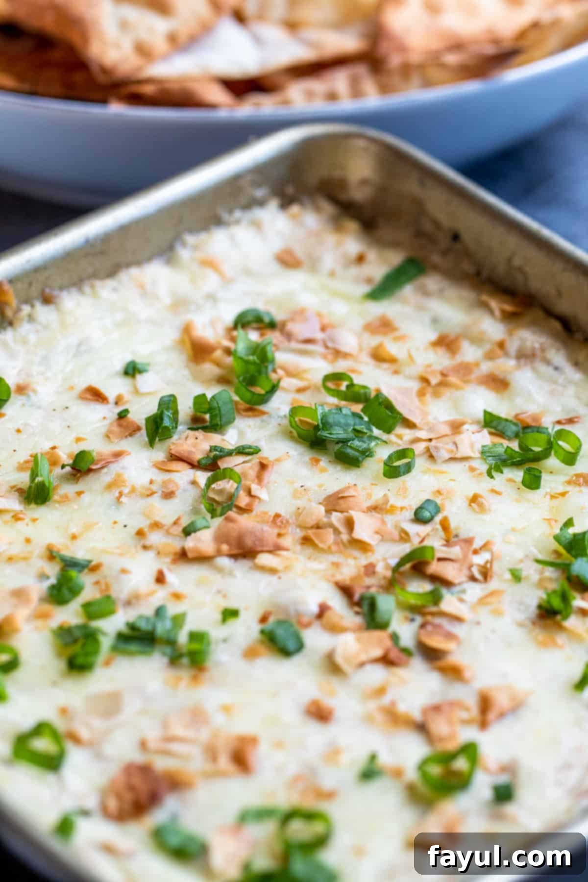 Creamy Crab Rangoon Dip with Crispy Wonton Dippers 3 Angle shot of dip in metal baking pan.