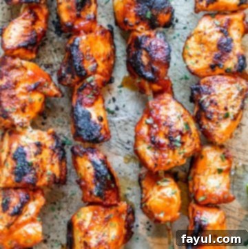 Overhead shot of chicken skewers on a cookie sheet.