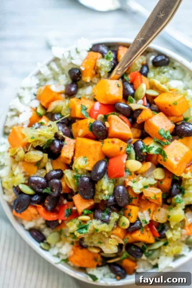 Effortless Veggie Burrito Bowls in Minutes 6 Overhead shot of burrito bowl with silver spoon sticking out.