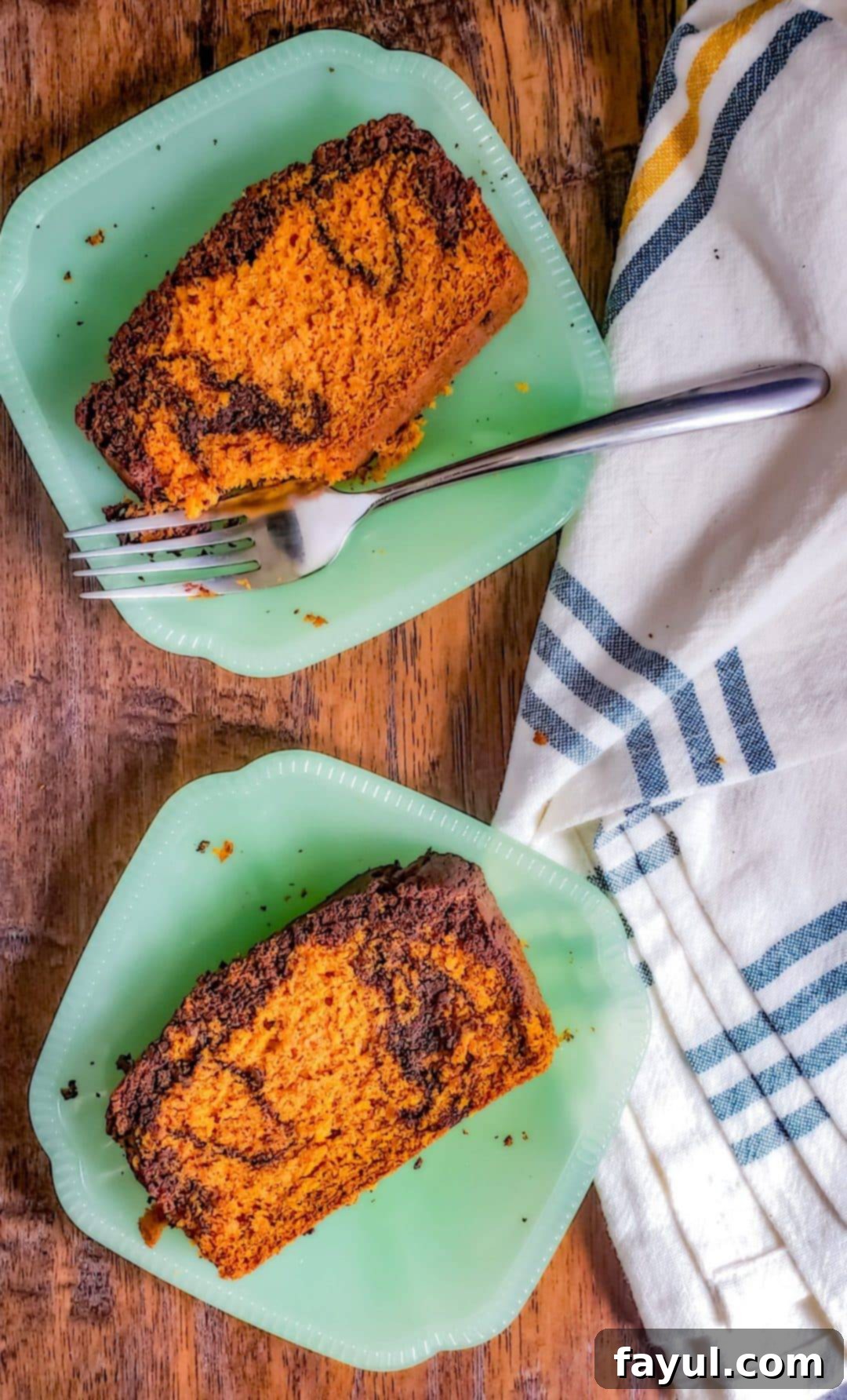 Overhead shot of two green plates with pumpkin bread on them.